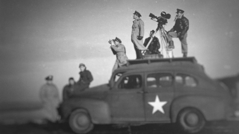 John Ford shooting WWII propaganda. Photo courtesy Netflix.