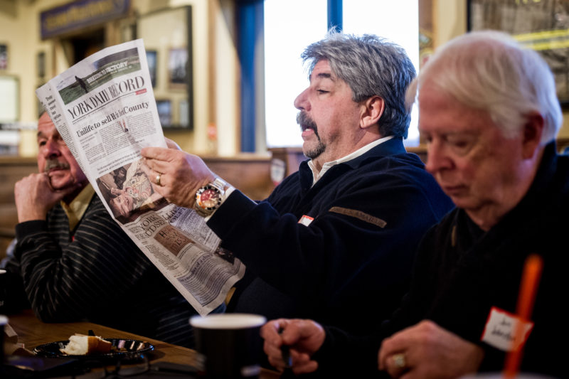 Joe Ambrosio flips through a recent edition of the York Daily Record during a discussion with YDR editors. (Photo by Jeff Lautenberger)